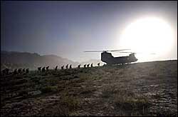 Soldiers from the 10th Mountain Division load into a Chinook helicopter atop a ridge in Oruzgan, Afghanistan. The unit patrols mountains near a U.S. outpost in Shkin. Photographs by David Swanson / Inquirer.