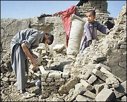 A resident of Kabuls Shirpur neighborhood works to repair damage to his home caused when the government ordered police to knock it down  to make way for luxury villas for the well connected.